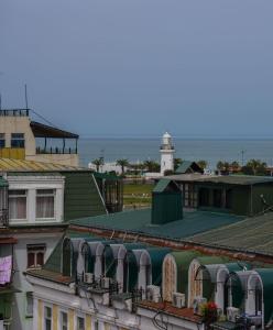 a view of the roofs of buildings with a lighthouse at Bel Mare Boutique Hotel in Batumi