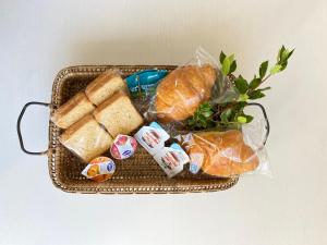 a basket filled with bread and other food items at Casa Dolci Rodolfo large bright apartment 4km to Seaside in Montemarciano