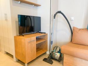 a vacuum cleaner sitting next to a television in a room at Mobil-home CAMARGUE in Vias