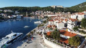 a city with a river and a town with boats at Apartments Caric in Hvar