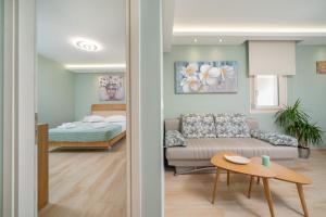 a living room with a couch and a bedroom at Villa STEPI in Chrysi Ammoudia