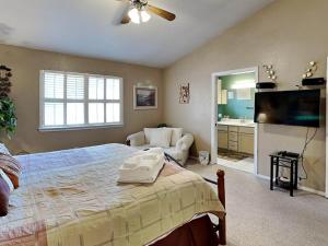 a bedroom with a bed and a flat screen tv at Touch of Santa Fe in Ruidoso +13 photos