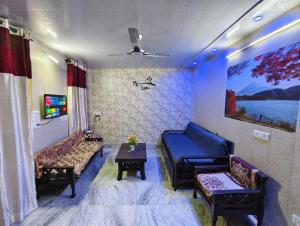 a living room with a blue couch and a table at Peaceful stay in New Delhi