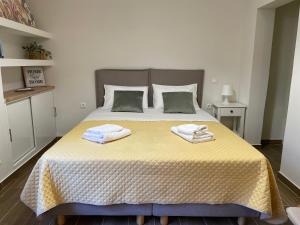 a bedroom with a bed with two towels on it at Cute studio near acropolis in Athens