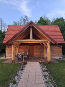 Cabaña de madera con techo rojo en Guest house Mihovil, en Slunj