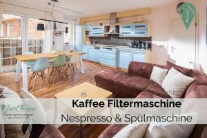 a living room with a couch and a table at Residenz am Meer 24C Strandkrabbe in Juist +7 photos