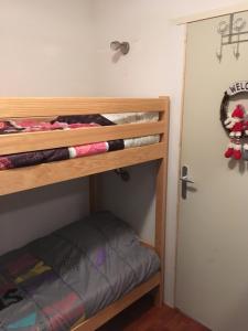 a bedroom with two bunk beds and a door at Reflets montagnards in Vignec