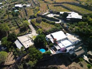 an aerial view of a house with a pool at I Dammusi di Punta Karace in Tracino