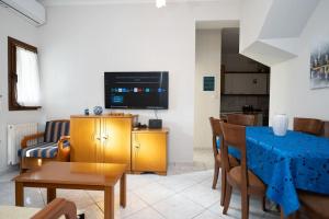 a living room with a couch and a television at Romance Dream Meteora 2 in Kalabaka