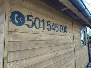 a wooden wall with the numbers on it at Domek Bałtycki Lux in Rewa