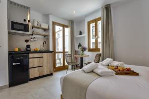 a bedroom with a large bed and a kitchen at MIMAR ALTEA ROOMS - Tranquil in Altea