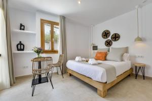 a bedroom with a bed and a table and a chair at MIMAR ALTEA ROOMS - Tranquil in Altea