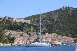 a sail boat in the water in front of a city at Blue Lagoon house in Hvar