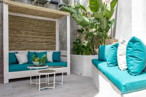 a patio with blue and white furniture and plants at MIMAR ALTEA ROOMS - Tranquil in Altea