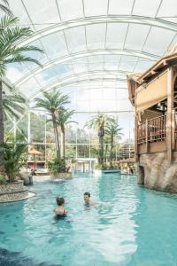 two people in the swimming pool at a resort at EurothermenResort Bad Schallerbach - Hotel Paradiso Superior in Bad Schallerbach