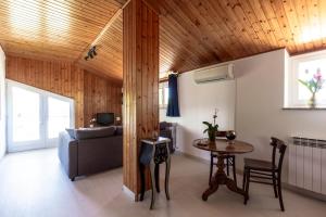 a living room with a couch and a table at Stanza in villa da Alberto in San Giorgio Canavese