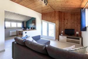 a living room with a couch and a tv at Stanza in villa da Alberto in San Giorgio Canavese