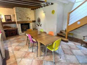 a dining room with a wooden table and chairs at Family house Bayeux - DDay in Subles