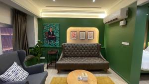 a waiting room with a couch and a bed at HABI Surawong-Silom in Bangkok