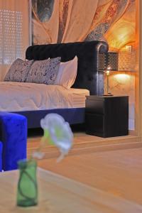 a bedroom with a bed and a table with a lamp at Hotel La Casa Blanca in Tetouan