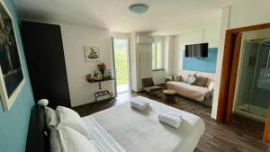 a bedroom with a bed and a living room at il Magàn - Cinque Terre in Corniglia