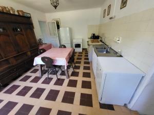 eine Küche mit Tisch, Spüle und Kühlschrank in der Unterkunft 607-Manoir de Pompren in Esquibien + 20 Fotos
