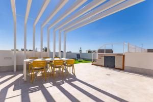 un patio con mesa y sillas en la azotea en Deluxe penthouse front line to the beach by Valcambre, en Costa Ballena