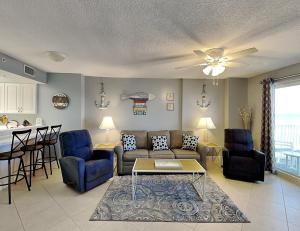 a living room with a couch and a table at Sea Winds 602 in Ormond Beach