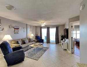 a living room with a couch and a table at Sea Winds 602 in Ormond Beach