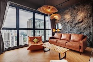 sala de estar con sofá y silla en Urban Suites, Autograph Collection by Stellar ALV, en Jelutong