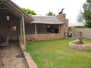 a backyard with a stone house with a fountain at Pecan Grove in Frankfort +12 photos