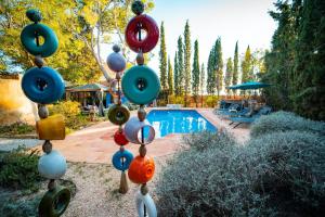 a group of ornaments on a pole next to a swimming pool at Catalunya Casas Rustic Vibes Villa with private pool 12km to beach in Vilafranca del Penedès