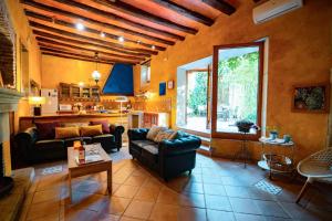 a living room with a couch and a table at Catalunya Casas Rustic Vibes Villa with private pool 12km to beach in Vilafranca del Penedès