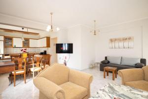 a living room with a couch and a dining room at Romance Dream Meteora 1 in Kalabaka