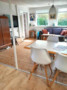 a living room with a table and chairs at The Beach House in Haderslev