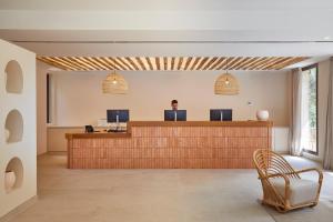 an office with a reception desk with a man sitting at it at Camping Cala Pola in Tossa de Mar