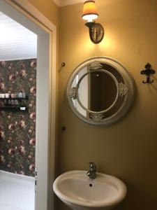 a bathroom with a sink and a mirror on the wall at Katerina 1 Bedroom House in Zakynthos