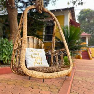 a wicker basket with a pillow on it at Casa Do Leão A 150 year Old Portuguese Home in Nerul