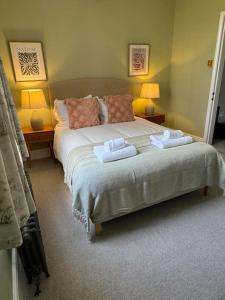 a bedroom with a bed with two towels on it at Chester City Centre townhouse in Chester