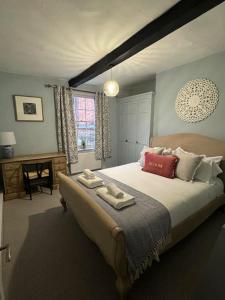 a bedroom with a large bed with towels on it at Chester City Centre townhouse in Chester