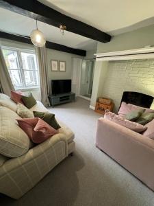 a living room with two couches and a television at Chester City Centre townhouse in Chester