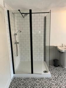 a shower with a glass door in a bathroom at Chester City Centre townhouse in Chester