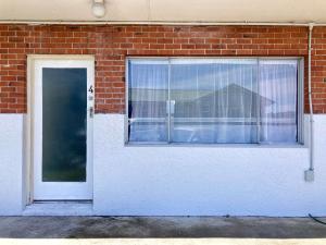 a door and a window in a brick building at 108 by the Lake in Taupo