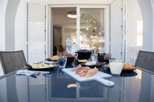 a table with a plate of food on it at Taheli Riverside Townhouse in Tourist Area in Paphos City +31 photos