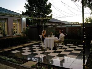 two women sitting at a table on a checkered patio at The Sweet Rose in Bloemfontein