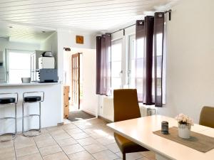 a kitchen and dining room with a table and chairs at Boddenwind No 3 in Zingst