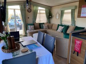 a living room with a couch and a table at Lodge - Sleeps 6 - Parking - Garden in Cockermouth