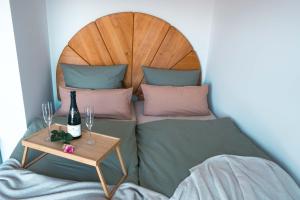 a bed with a table with a bottle of wine at Ferienwohnung Weitblick im Dahner Felsenland in Bruchweiler-Bärenbach +43 photos
