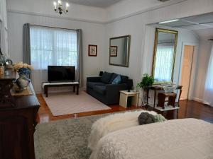 a living room with a bed and a couch at Memory Lane Accommodation in Mount Tamborine