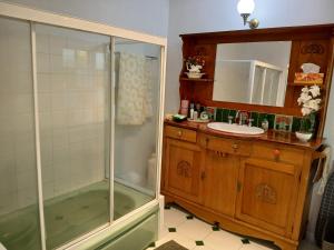 a bathroom with a shower and a sink at Memory Lane Accommodation in Mount Tamborine
